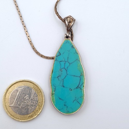 582 - A Bohemian style tear drop pendant necklace, set with a large central Turquoise stone and a Marcasit... 