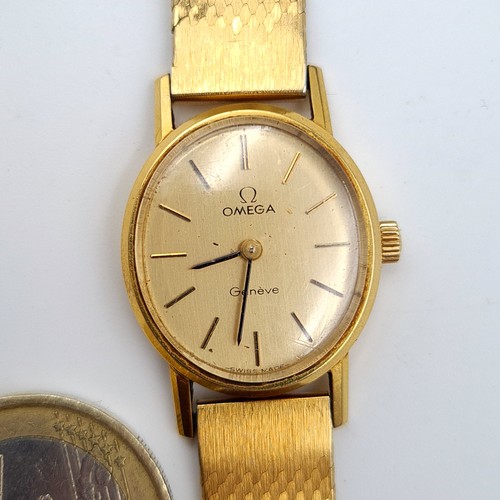 584 - Star Lot : An exceptional vintage genuine Gold 750 Omega ladies wrist watch, set with a beautiful go... 