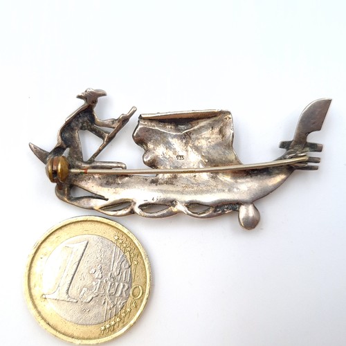 591 - An attractive brooch, in the form of a Gondola with a Gondolier. This example is set in sterling sil... 