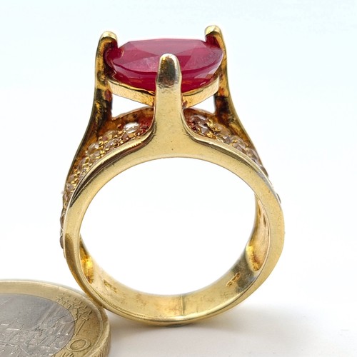 601 - Star Lot: An exceptional Ruby and Diamond silver gilt cocktail ring, featuring a generous central Ru... 