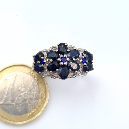 602 - A jaw dropping Sapphire multi stone ring, set with Marcasite detail and forming a fabulous floral mo... 