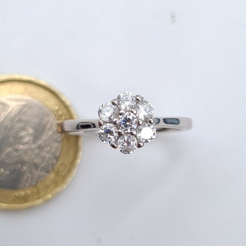 604 - A 9 carat White Gold stamped 375 White Sapphire daisy ring. Ring size: P. Weight: 2.6 grams. Very ni... 