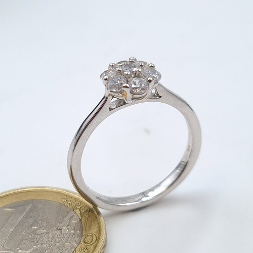 604 - A 9 carat White Gold stamped 375 White Sapphire daisy ring. Ring size: P. Weight: 2.6 grams. Very ni... 