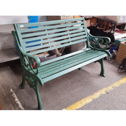 538 - A fabulous outdoor garden bench with heavy cast metal frame and slatted wooden seat, in a green fini... 