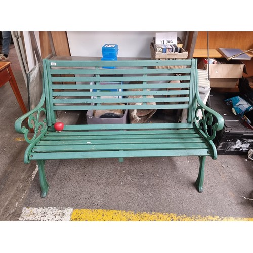 538 - A fabulous outdoor garden bench with heavy cast metal frame and slatted wooden seat, in a green fini... 