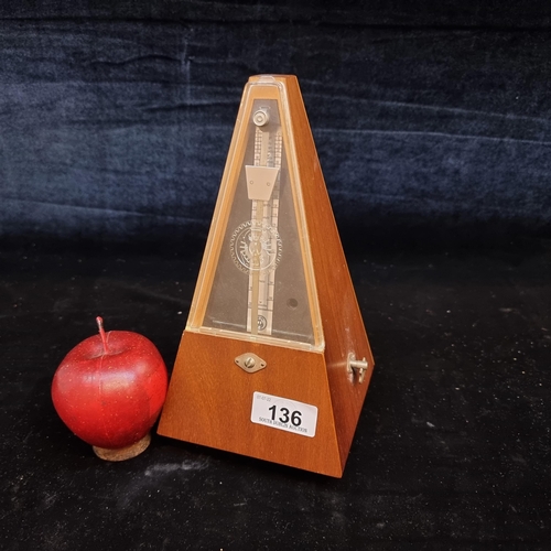 136 - A vintage pyramidal metronome with swinging pendulum to centre.