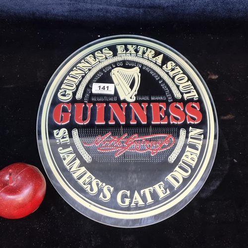 141 - A oval wall mirror advertising Guinness Extra Stout.