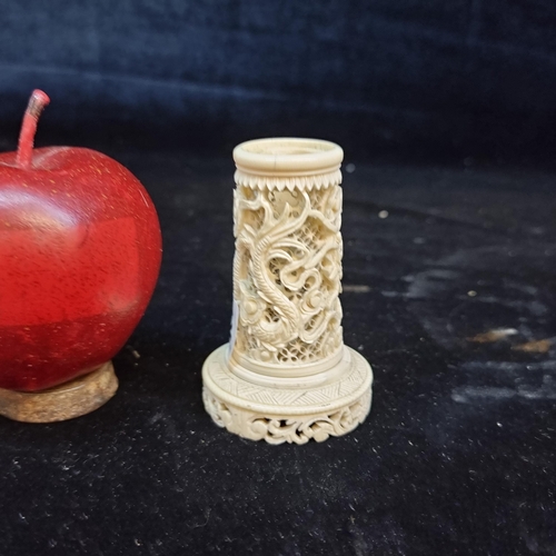 142 - A small Chinese puzzle ball stand with pierced lattice back and dragon motif.