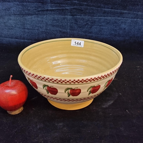 144 - A large Nicholas Mosse pottery fruit bowl with apple motif to side and makers stamp to base.