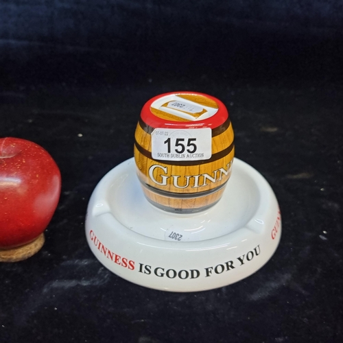 155 - A Guinness branded ashtray and match-striker. With a beer barrel centre and slogan ''Guinness Is Goo... 