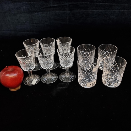 157 - A selection of ten cut crystal drinking glasses including six Waterford Crystal footed liqueur glass... 