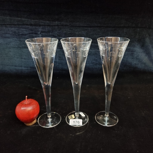 176 - A trio of  large John Rocha for Waterford Crystal champagne flutes in the Geo pattern. In good condi... 