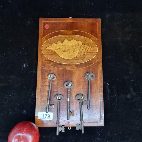 179 - A handsome Edwardian key rack with detailed conch shell marquetry motif in satinwood with extensive ... 