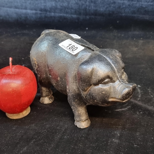 180 - A cast metal piggy bank. A charming and heavy money box in a black gloss finish.