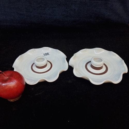 186 - A pair of Stephen Pearce terracotta candle holders for Shanagarry pottery studio with the striking w... 