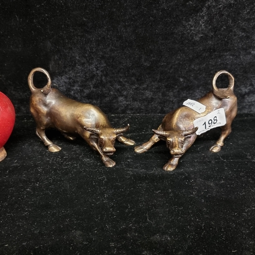 198 - Star Lot : A fabulous pair of cast bronze bull figures in animated poses. Heavy quality pieces.