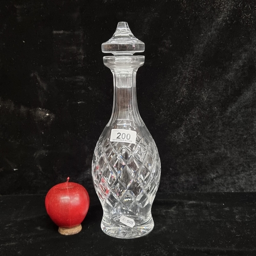 200 - An elegant Waterford Crystal decanter in the Comeragh pattern with faceted stopper and acid mark to ... 