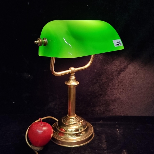 206 - A handsome vintage bankers lamp with a brass column base and a green glass shade.