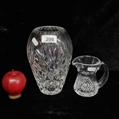 208 - Two crystal items including a Waterford Crystal cream jug along with a large vase with a rounded top... 