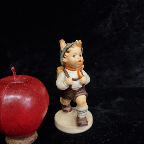 211 - A vintage Hummel Goebel ceramic school boy figure. With mark to base and in very good condition.