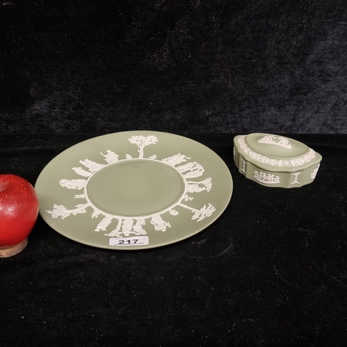 217 - Two pieces of green Wedgwood pieces including a plate and a lidded ring dish. Both featuring a white... 