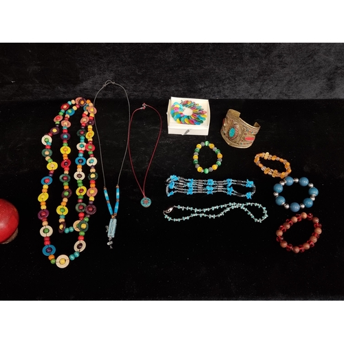 222 - A selection of 11 costume jewellery items including colourful beaded necklaces, bracelets and an inl... 