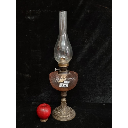 238 - A beautiful vintage oil lamp with an ornate brass base, a delicate pink glass bowl and complete with... 