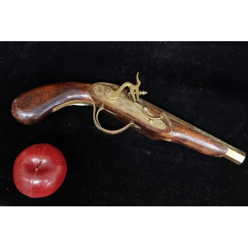 243 - A fantastic flintlock pistol boasting brass fittings throughout with attractive etched foliate ornam... 