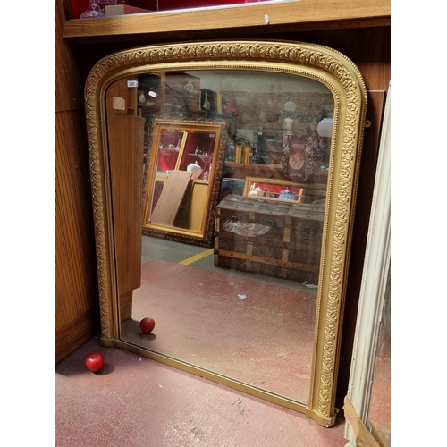 288 - Star lot : A very large antique over mantel mirror held in an ornate gilt frame boasting foliate and... 