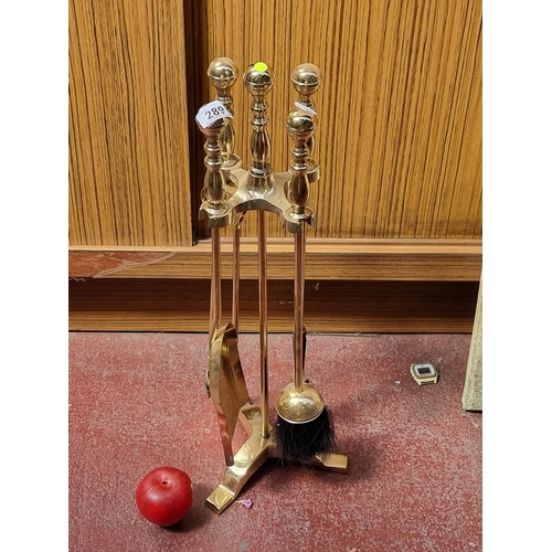 289 - A heavy excellent quality brass fireside companion stand. A complete four piece set with ball finial... 