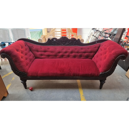 317 - Star lot : An elegant victorian sofa with a beautifully carved backrest and roll armrests featuring ... 