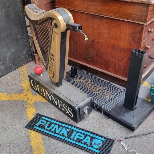 325 - Star Lot : Two Guinness branded items including a double sided light-up sign in the form of a harp a... 