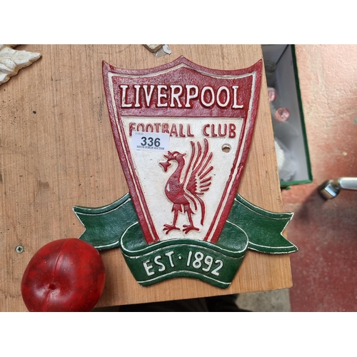 336 - A  cast metal wall plaque depicting the Liverpool Football Club crest.