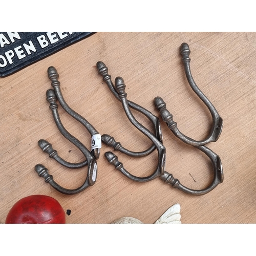 339 - A set of six cast metal wall coat and hat hooks.