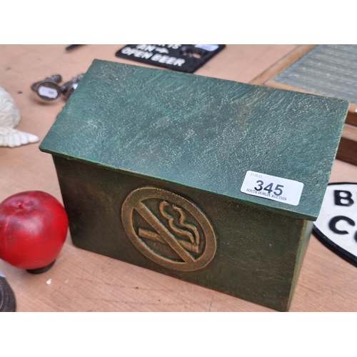 345 - A very heavy cast metal wall cigarette bin with a relief 'no smoking' symbol to front and a lid to r... 