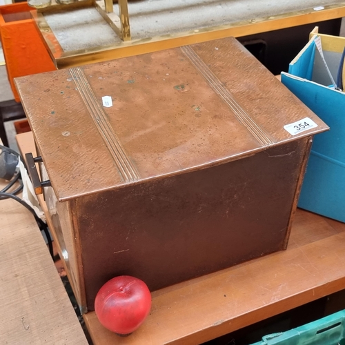 354 - An antique copper coal box with a hinged lid, handles to sides and two feet to the back H25cm x W35c... 