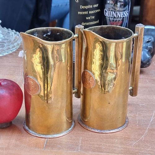 360 - Two antique brass and copper trench art pitchers with angular handles and each retaining a Portugues... 