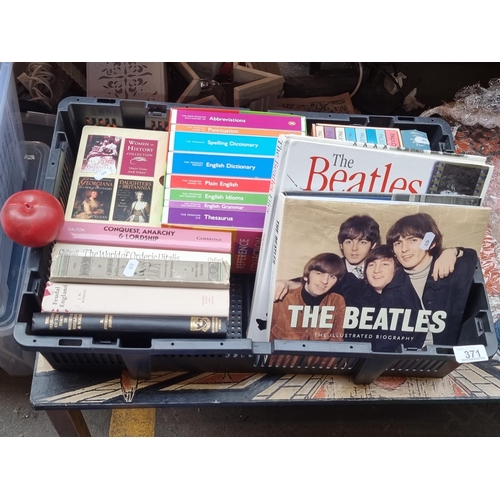 371 - A box filled with books including those on the Beatles, box set of works by Paula Coelho, and Women ... 