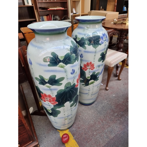 387 - Star lot : Two very large and tall ceramic vases, with Chinese lily ornament to side. Mm: 95 cm tall... 