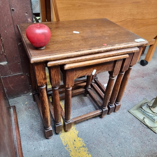 389 - A set of three oak vintage nesting tables with turned wood legs.