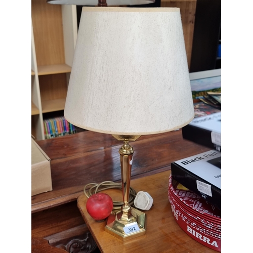 392 - A heavy vintage table lamp with brass hexagonal base topped in a cream shade.