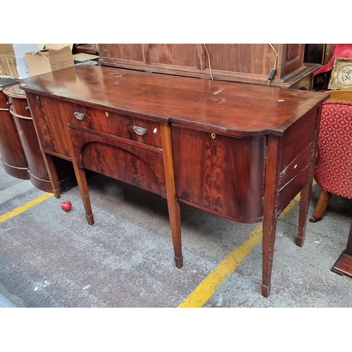 398 - Star Lot : A handsome antique Georgian flamed mahogany sideboard. With spade legs and brass drop rin... 