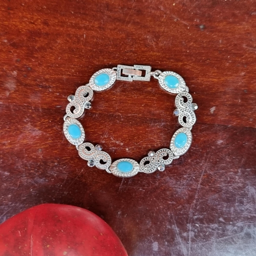 408 - A very pretty sterling silver bracelet, featuring pretty turquoise and swirl spaces. Marked 925. Dia... 