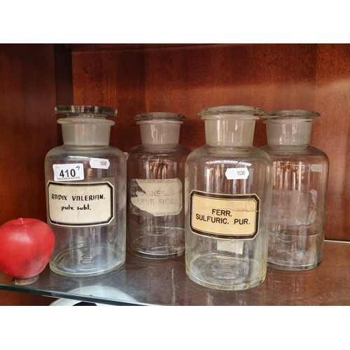 410 - A set of four large Chemist's jars complete with glass stoppers and three sporting original labels. ... 