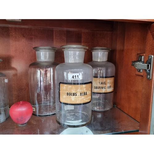 411 - A set of three extra large Chemist's jars complete with glass stoppers and two sporting original lab... 