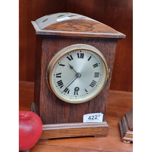 422 - A handsome vintage time-only mantle clock. Housed in a heavy oak wood case with roman numeral dial a... 