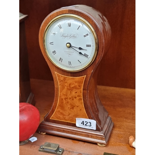 423 - An elegant Knight-Gibbons mantle clock with burl walnut and satinwood inlay. With convex face and ro... 