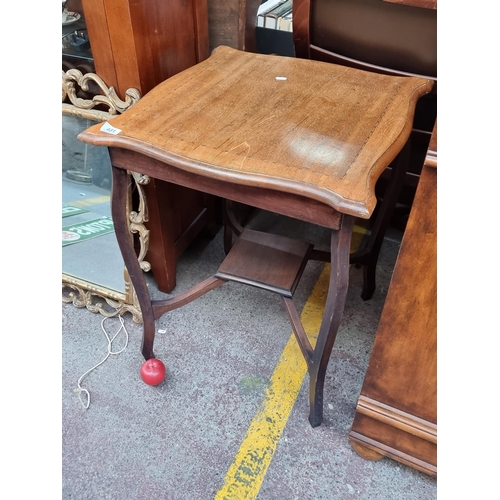 431 - An Edwardian side table with serpentine edge and string inlay sporting second tier to base.