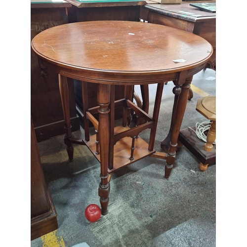 444 - Star Lot : A lovely antique round occasional table with undertier boasting turned wood spindles. Rou... 