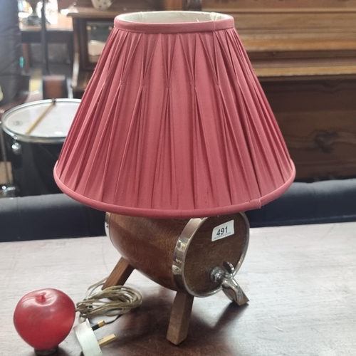 491 - A charming vintage spirit barrel lamp with a chrome tap and topped with a red pleated shade.